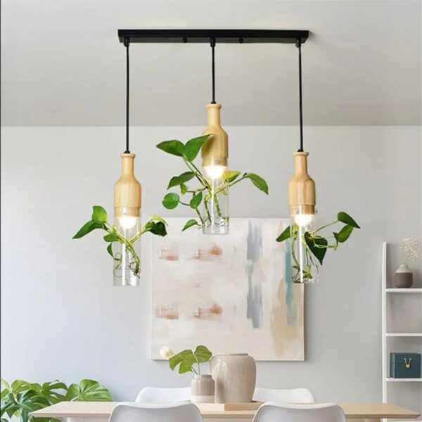Suspension design triple avec bouteilles de verre illuminées
